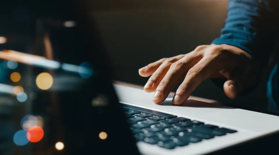 a person typing on a laptop